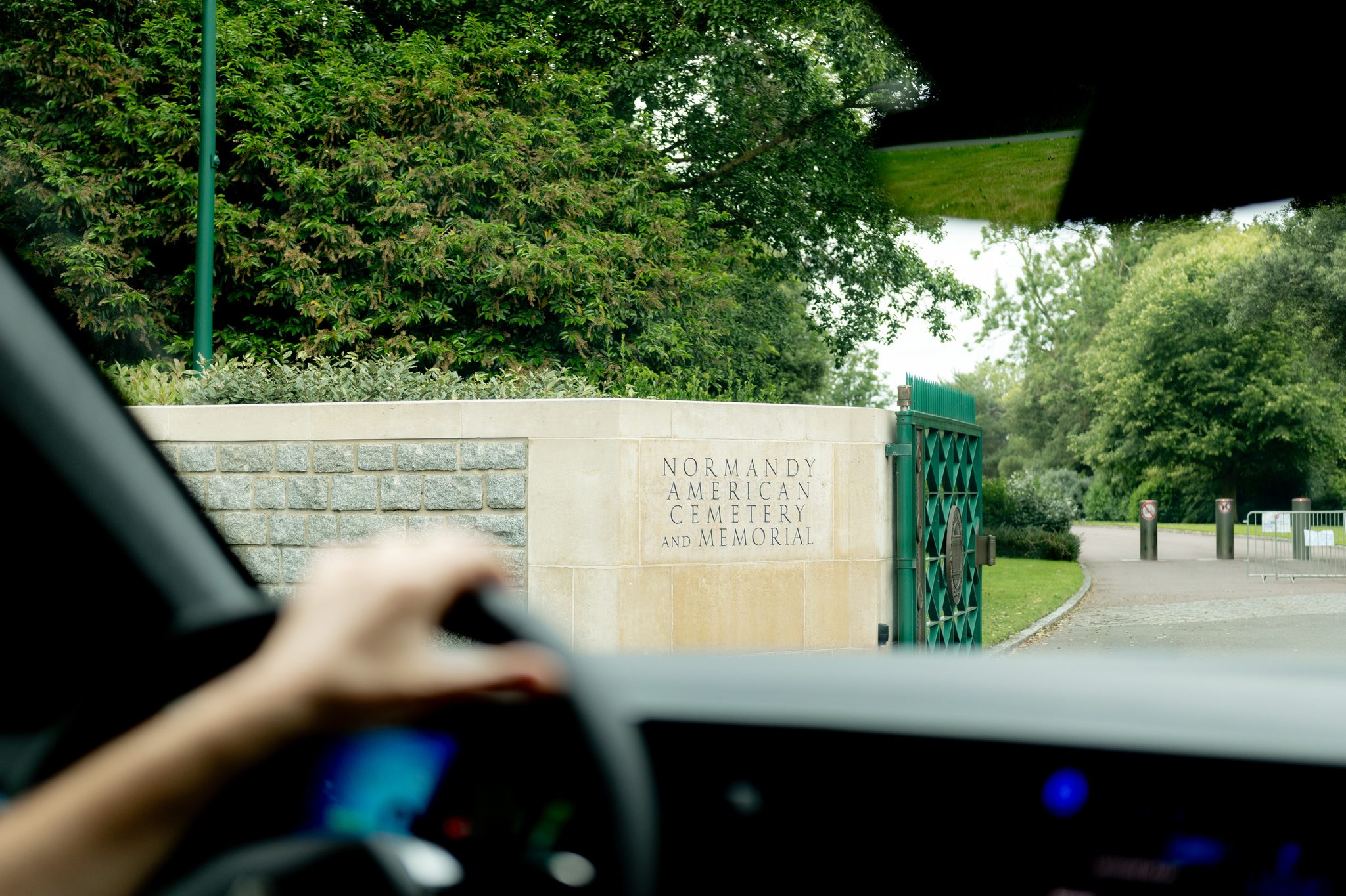 View from inside a car arriving at the Normandy American Cemetery for a guided tour.